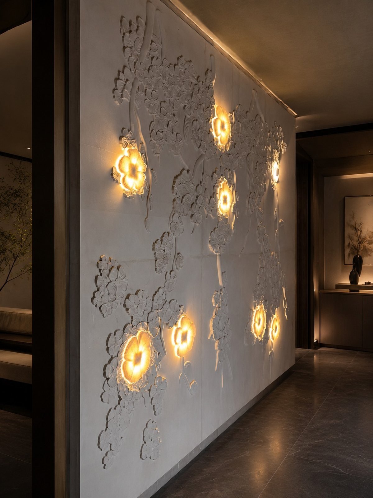 Backlit carved marble blossom feature wall glowing from behind
