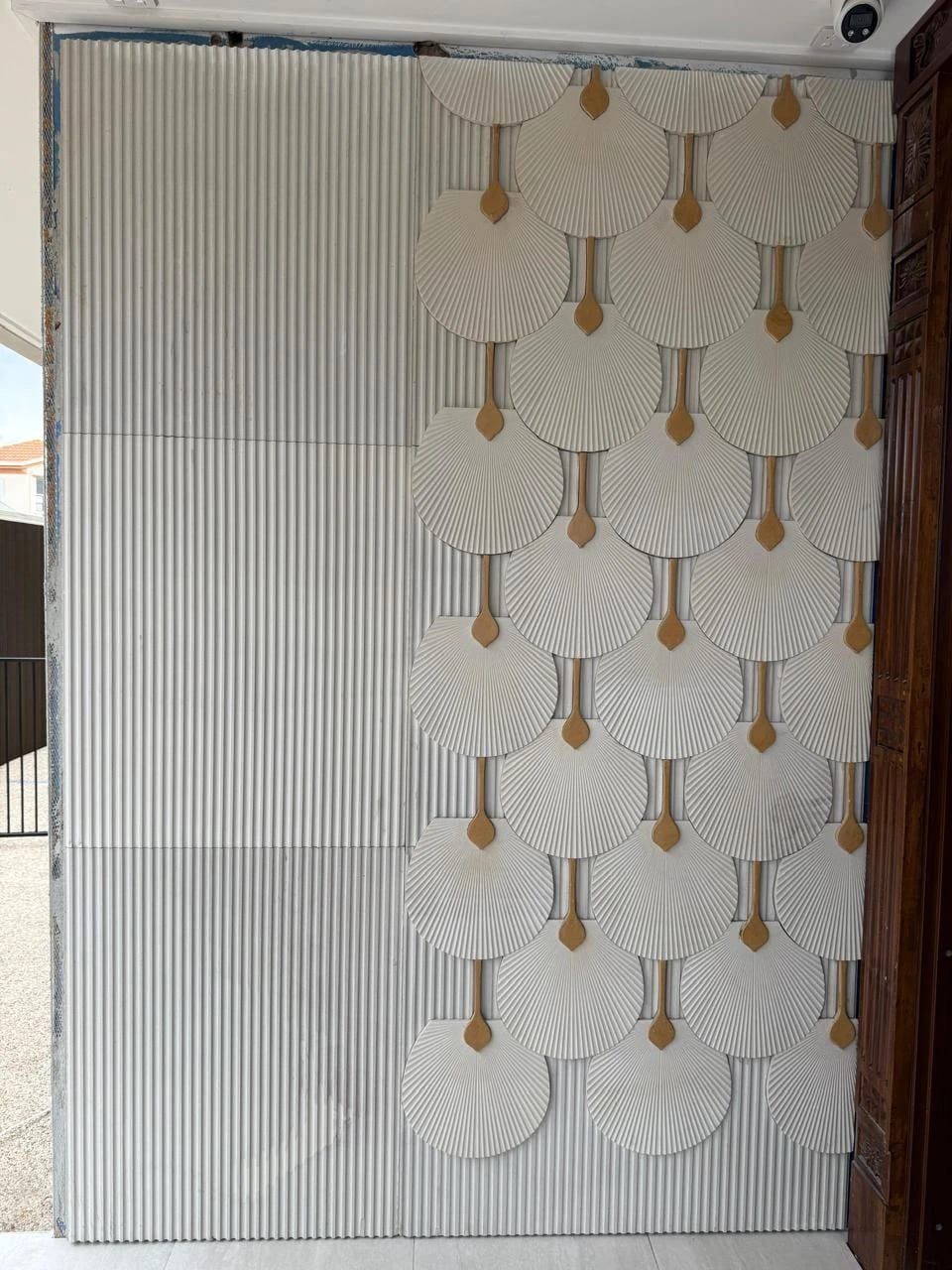 Full elevation of a hand-finished white marble and brass wall mural